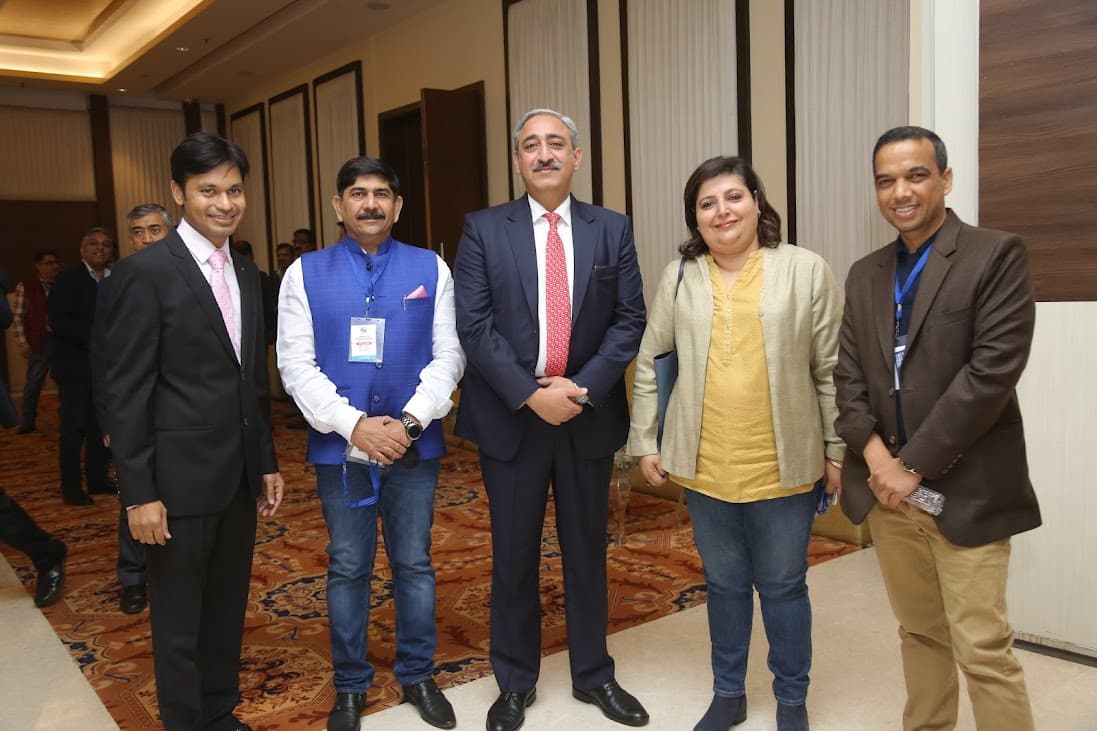 Captain Uday K. Shriwas with a small networking group at an indoor event
