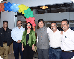 Capt Uday K. Shriwas posing with a group of professionals at an indoor networking event