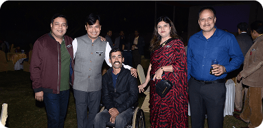 A small group of professionals posing together at an evening networking gathering