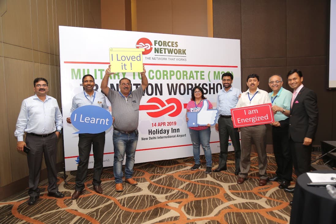 Community members holding placards at a Forces Network event