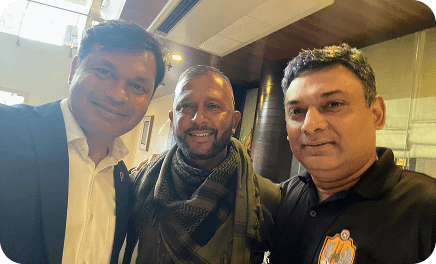 Three unnitee attendees posing for a selfie at an indoor event
