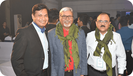 Three unnitee community members posing together at an indoor gathering