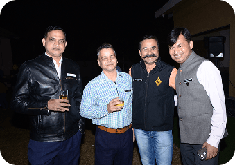Four unnitee community members posing together at an evening event