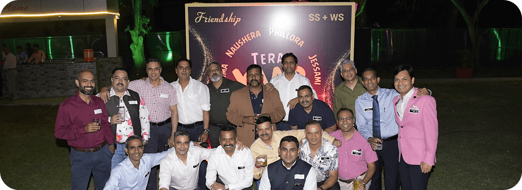 Outdoor group photo of professionals gathered at an evening networking event