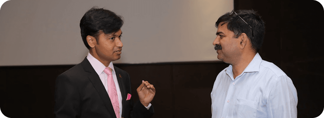 Two professionals in conversation during an event